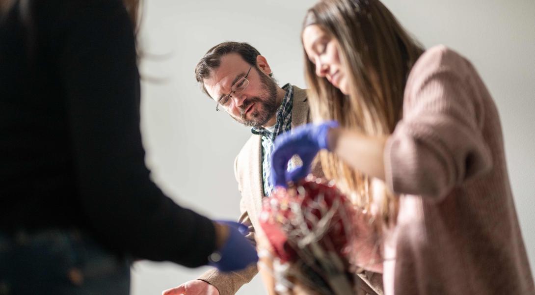 Patrick Cox watches students use an EEG cap to study the brain's reactions